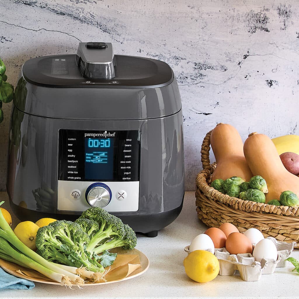 deluxe multi cooker from pampered chef a pressure cooker with vegetables in a basket